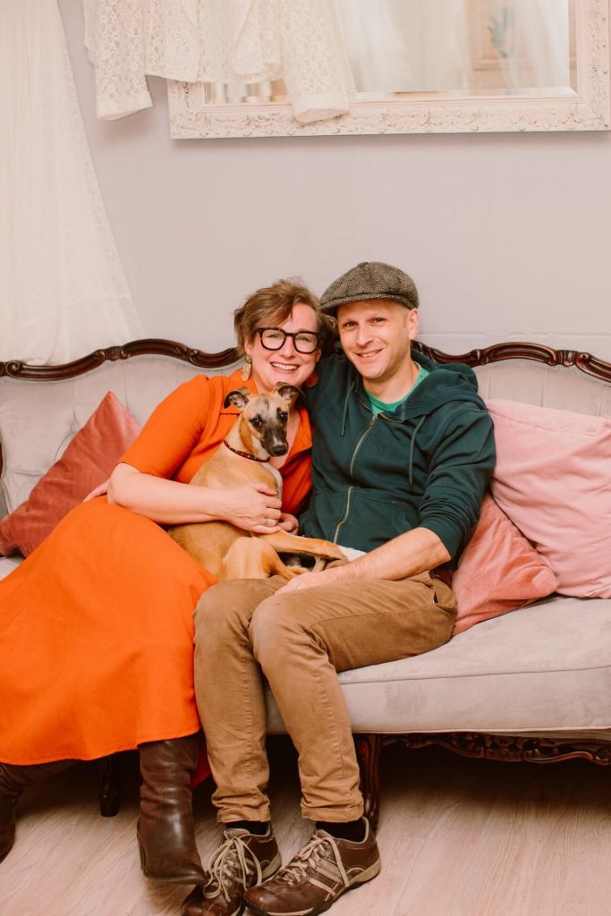 Kate & Will Ashwell holding their puppy on the sofa at Ashwell & Co shop