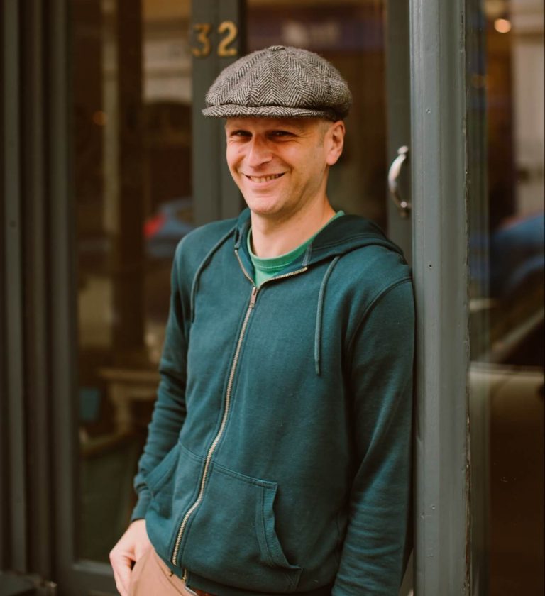 Will Ashwell laughing, stood in front of Ashwell & Co shop in Bristol