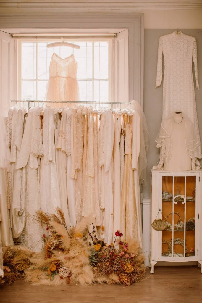 inside the Ashwell & Co shop, a rail of vintage dresses in cream and ivory fabrics