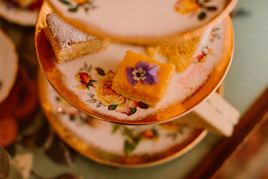 vintage crockery with pretty flower topped cakes at Ashwell & Co