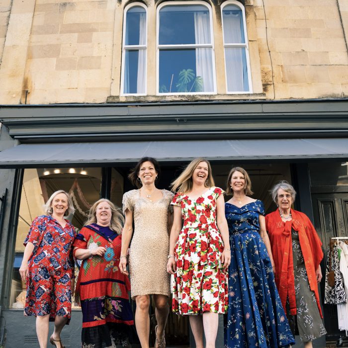Ladies smiling in vintage dresses outside the Ashwell & Co shop