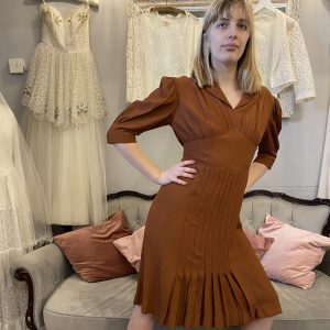 Step into a piece of fashion history with our Very Rare 1930s Rust Day Dress. Crafted with meticulous attention to detail, this exquisite garment exudes timeless elegance and sophistication. A true treasure for vintage enthusiasts and collectors alike, it's perfect for making a statement at any occasion.